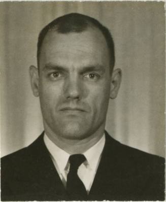 Black and white portrait of Pierce Yarrell Matthews Jr., wearing a dark jacket and tie