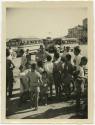 Black and white image of Pierce Yarrell Matthews Jr. in civilian clothing talking to a group of…