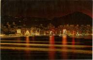 Printed postcard with color photograph of Hong Kong at night from the water