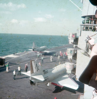 Color slide depicting aicraft on the flight deck with the island visible on the right