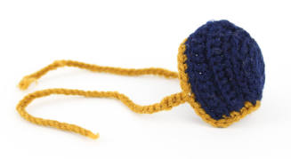 Side view of dark blue round knit nose warmer with gold edges and gold knit ties