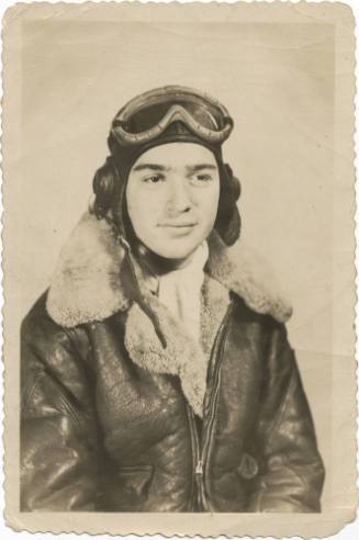 Black and white photograph of Irwin Cohen in a winter flight suit and helmet