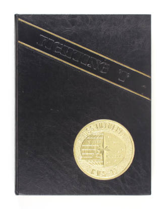Black hardcover USS Intrepid cruise book for 1972–1973 with gold Intrepid seal and "Fighting I"…