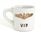 White mug, gold image of submarine dolphins insignia and "VIP" on face