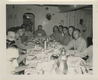 Black and white photograph of officers sitting at a table for a meal