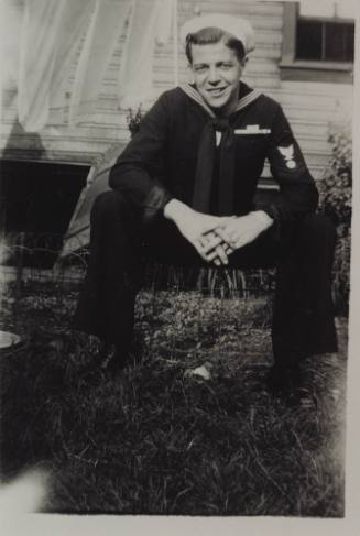 Black and white photograph of sailor Robert N. Mary in a dress blue uniform sitting down