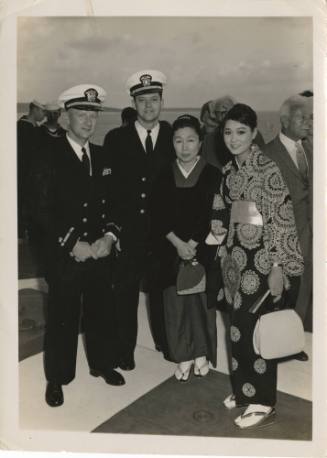 Black and white photograph with officers from USS Intrepid and Japanese movie stars