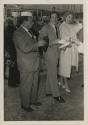 Black and white photograph of actors Edward G. Robinson, Gene Kelly and Rhonda Fleming visiting…