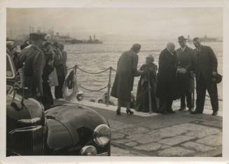 Black and white photograph of Winston Churchill in Gibraltar with USS Intrepid in the distance
