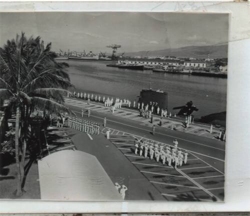 Black and white photograph of sailors in white uniforms manning USS Growler's rails in Pearl Ha…