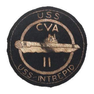 Circular black patch with the words "USS Intrepid CVA-11"and an image of the aircraft carrier i…