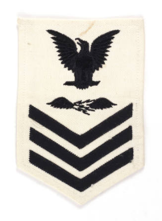 White U.S. Navy uniform patch with dark blue eagle, chevrons and image of lightning bolts with …