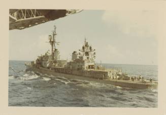 Color photograph of the destroyer USS Bausell (DD-845) at sea