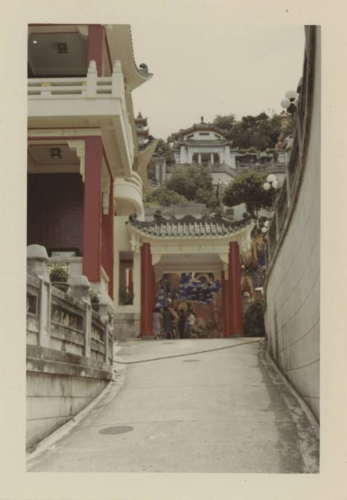 Color photograph of Tiger Balm Garden in Hong Kong, showing a path and structures with red pill…