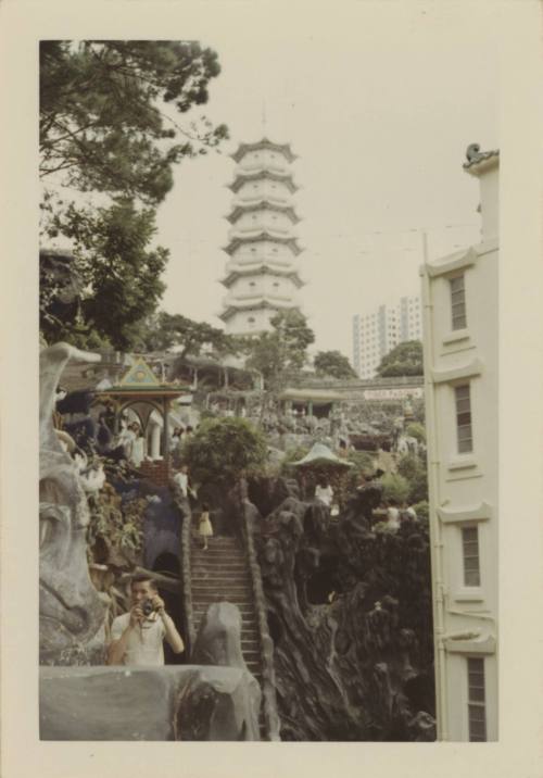 Color photograph of the Tiger Pagoda in Hong Kong, which sits atop a hill with a stairway