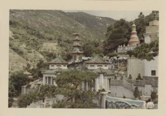 Color photograph of Tiger Balm Garden in Hong Kong, with decorative buildings and pagodas on a …