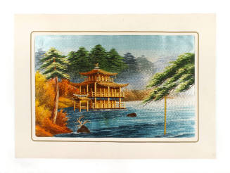Colored embroidered picture of a pagoda building next to water surrounded by orange and green f…