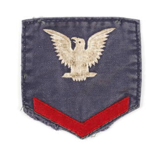 Denim U.S. Navy uniform patch with an eagle embroidered in white above a red chevron