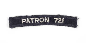 Dark blue US Navy shoulder patch with “Patron 721” sewn in white