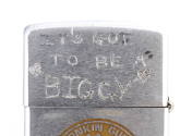 Lid of silver lighter with sratched inscription “It’s Got To Be A 'Biggy'”