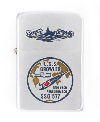 Silver lighter with an enameled USS Growler seal, which depicts the submarine Growler in the At…