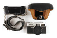 Canon Canonet QL17 camera displayed alongside the two parts of its black leather case with stra…