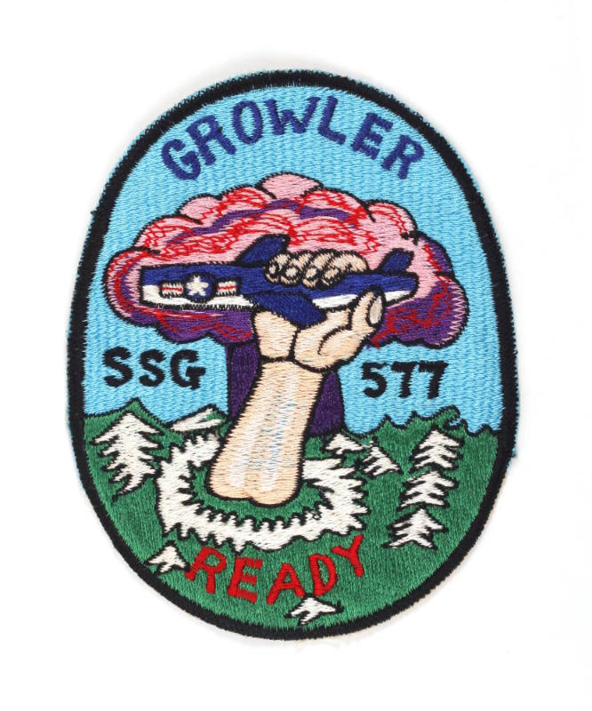 Oval USS Growler patch, depicting a hand reaching out of green water and grabbing a Regulus I m…