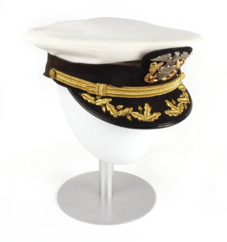 U.S. Navy officer combination cap with white cover and gold oak leaf embroidery on visor, displ…