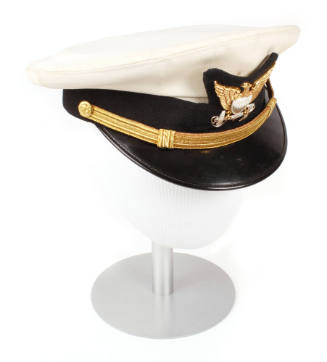 U.S Coast Guard officer service dress peaked combination cap atop mannequin head form