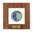 Square plaque with an inset white ceramic tile that depicts circular USS Intrepid seal, metal l…