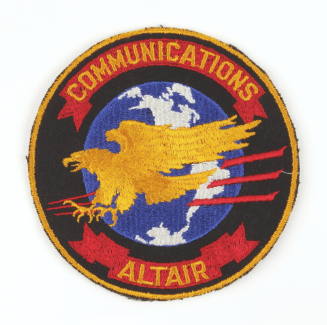 Circular embroidered patch that reads "Communications Altair" with a yellow eagle against and b…
