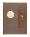 Brown hardcover cruise book with a gold emblem on one side and "The Fighting I" on the other