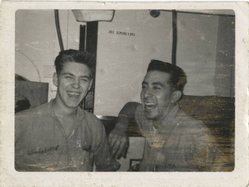 Black and white photograph of two men laughing