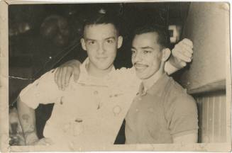 Black and white photograph of two men with their arms around each other's shoulders