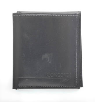 Folded black, tri-fold leather wallet, imprinted on the bottom, right corner is text that reads…