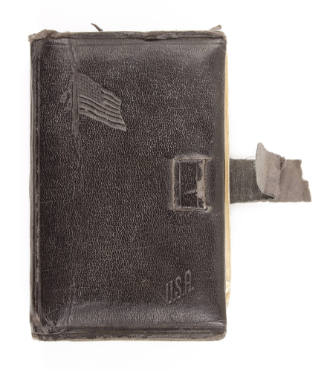 Black missal in a leather cover with imprinted American flag and a broken clasp