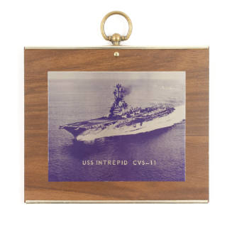 Rectangular wood plaque with blue and white image of the aircraft carrier USS Intrepid at sea