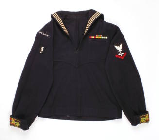 U.S. Navy blue dress jumper with Vietnam War service ribbons on the chest and dragon patches se…
