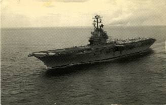Image side of a postcard with a black and white photograph of USS Intrepid at sea