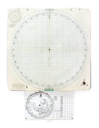 Square, white plotting board with green concentric circles extending from the center