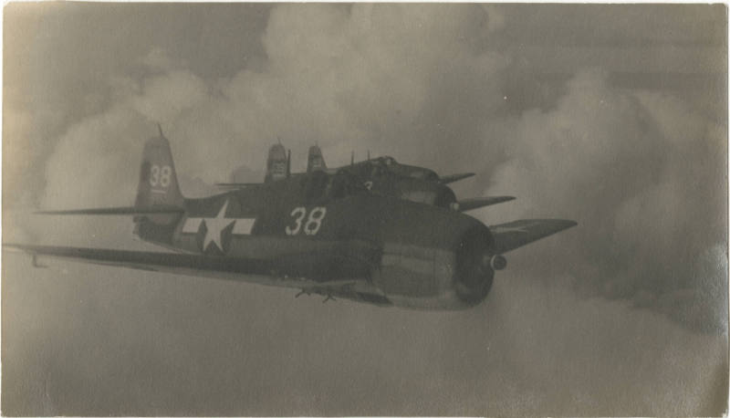 Black and white photograph of three F6F Hellcats in flight
