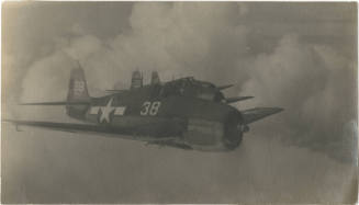 Black and white photograph of three F6F Hellcats in flight