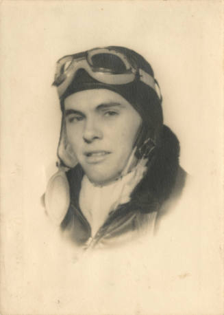 Black and white portrait photograph of Ralph DuPont in a pilot's helmet