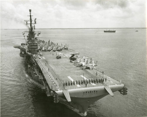 Black and white photograph of Intrepid at sea with aircraft on the flight deck