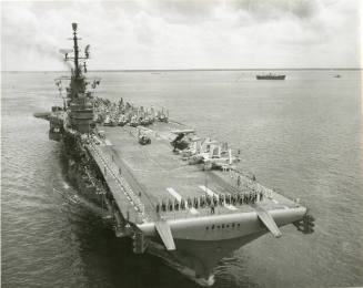 Black and white photograph of Intrepid at sea with aircraft on the flight deck