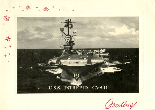 Printed holiday card with a black and white photograph of USS Intrepid at sea and red snowflake…