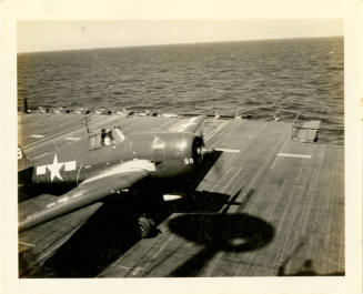 Printed black and white photograph of a Grumman TBF-1C Avenger on the flgiht deck