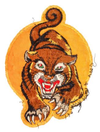 Embroidered circular yellow patch depicting a tiger advancing forward with teeth bared and claw…