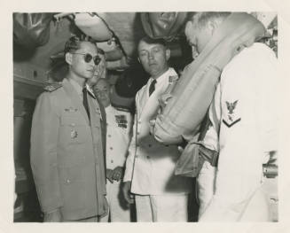 Printed black and white photograph of the King of Thailand on board the submarine USS Growler