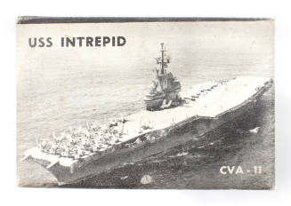 Cover of 1958 day planner calendar, with a black and white photograph of USS Intrepid at sea an…